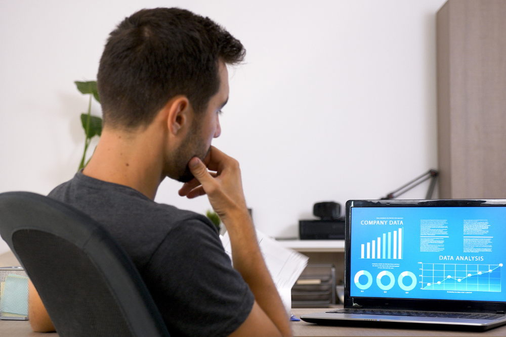Man reviewing analytics and campaign performance to improve social media strategies.