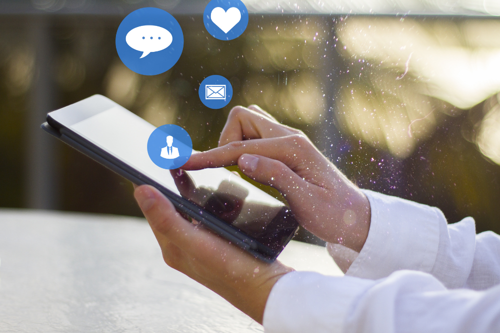 Person using a tablet to manage online engagement for social media marketing.